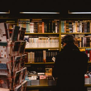 Individual browsing books in a cozy Saint Petersburg bookstore, offering a warm literary atmosphere.
